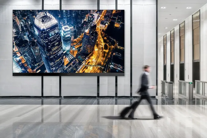 Indoor LED screen installed behind a hotel reception desk