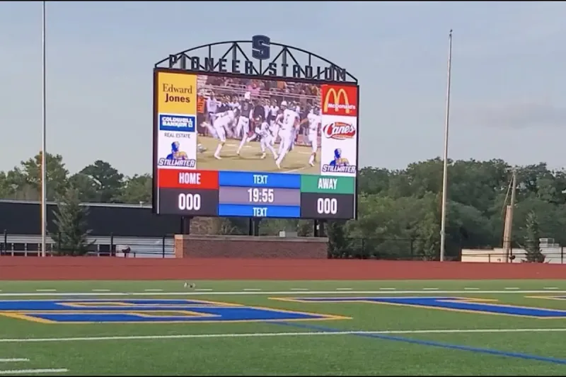 Large jumbotron stadium LED screen showing live football content