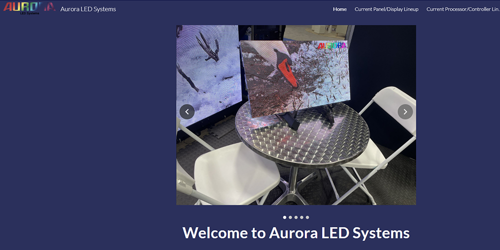 Hero image showing LED display panels around a round metal table with white folding chairs in a showroom; Welcome to Aurora LED Systems text visible below.