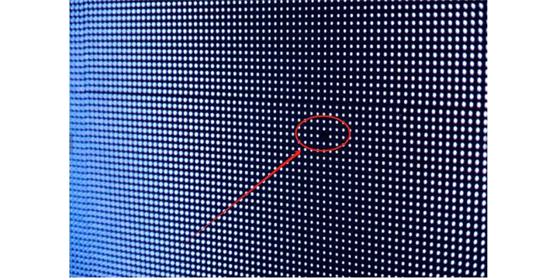 black spot2 - LED Screen Board - LED Screen Board Close-up of a blue LED dot grid with a small defect circled by a red ring and arrow pointing to it.