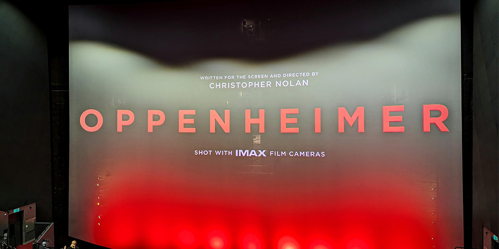 02-BFI-IMAX-London - LED Screen Board - LED Screen Board Movie poster for Oppenheimer displayed on a cinema screen with red lighting at the bottom