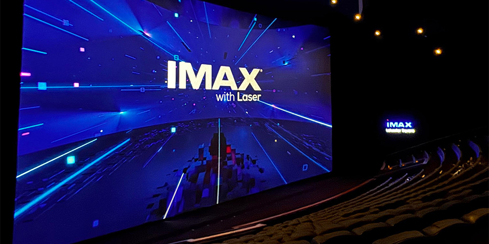 06-Cineworld-Leicester-Square - LED Screen Board - LED Screen Board IMAX with Laser cinema screen showing blue neon graphics in a dark theater