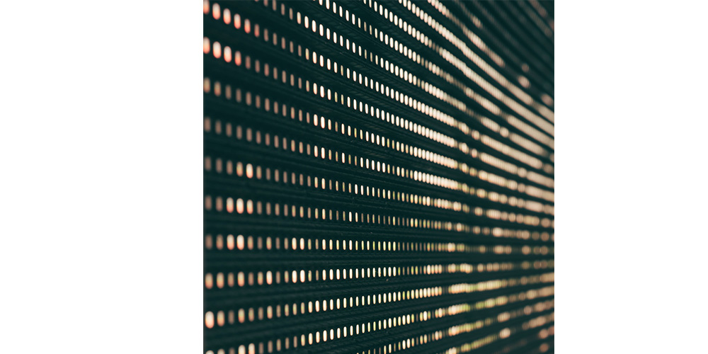 Black LED Display1 - LED Screen Board - LED Screen Board Close-up of a perforated metal surface with evenly spaced circular holes creating a striped pattern.