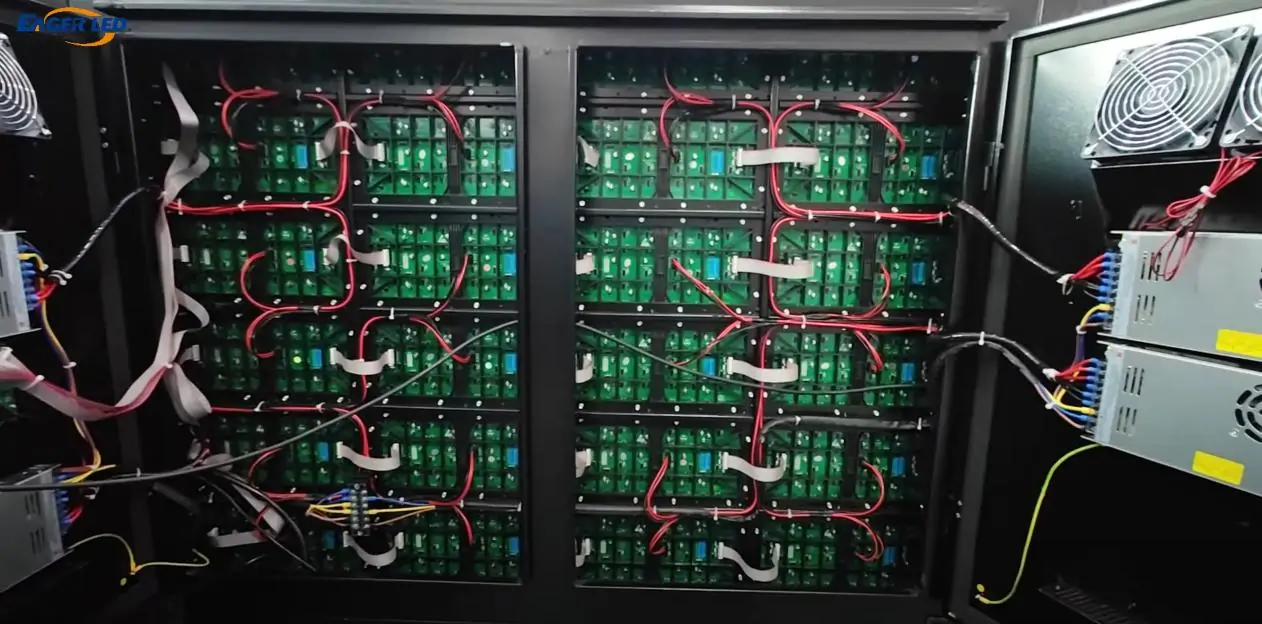 Open LED display cabinet showing circuit boards, wiring, cooling fans and power supplies