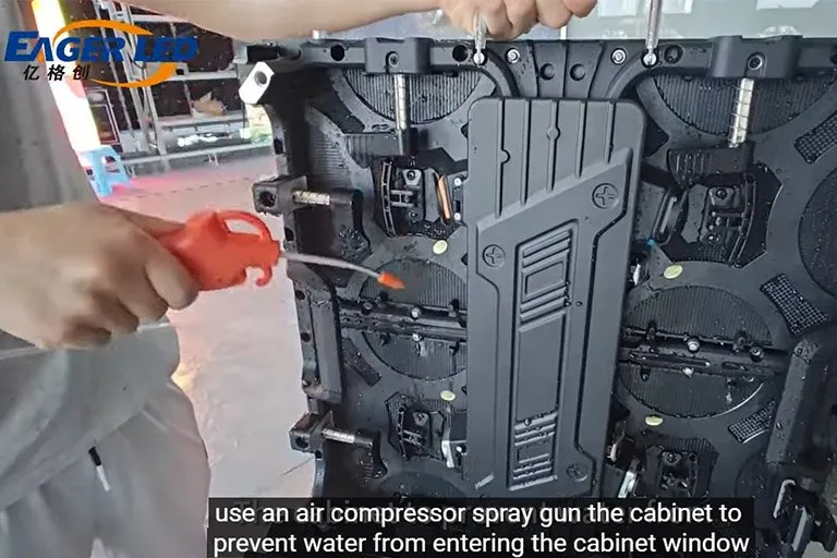 EagerLED technician treating an outdoor LED advertising board cabinet in the factory waterproof test area